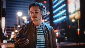 Person with Headphones Listening to Podcast