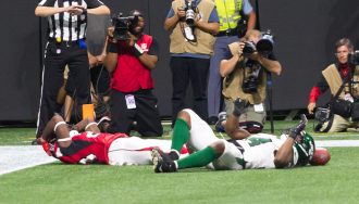 Football Player Being Taken Off Field on Stretcher