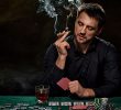 A man playing poker while friends sitting on table in casino