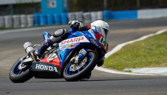 A person riding a motorcycle on a racetrack