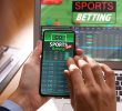 Man using smartphone for betting on sports