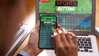 Man using smartphone for betting on sports