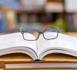 A pair of glasses on top of books